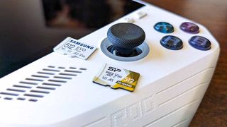ROG Ally with microSD cards on top of it.